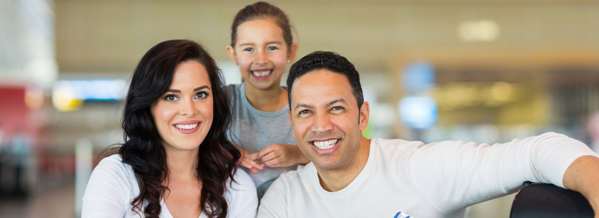 Happy family at the airport with passports – Study Abroad, Family Visa & Migration Services Image