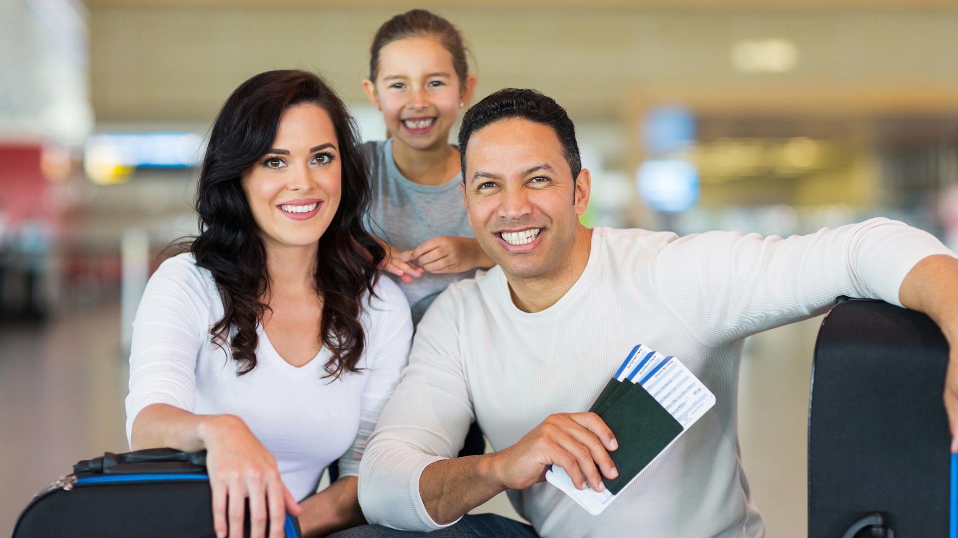 Happy family at the airport with passports – Study Abroad, Family Visa & Migration Services